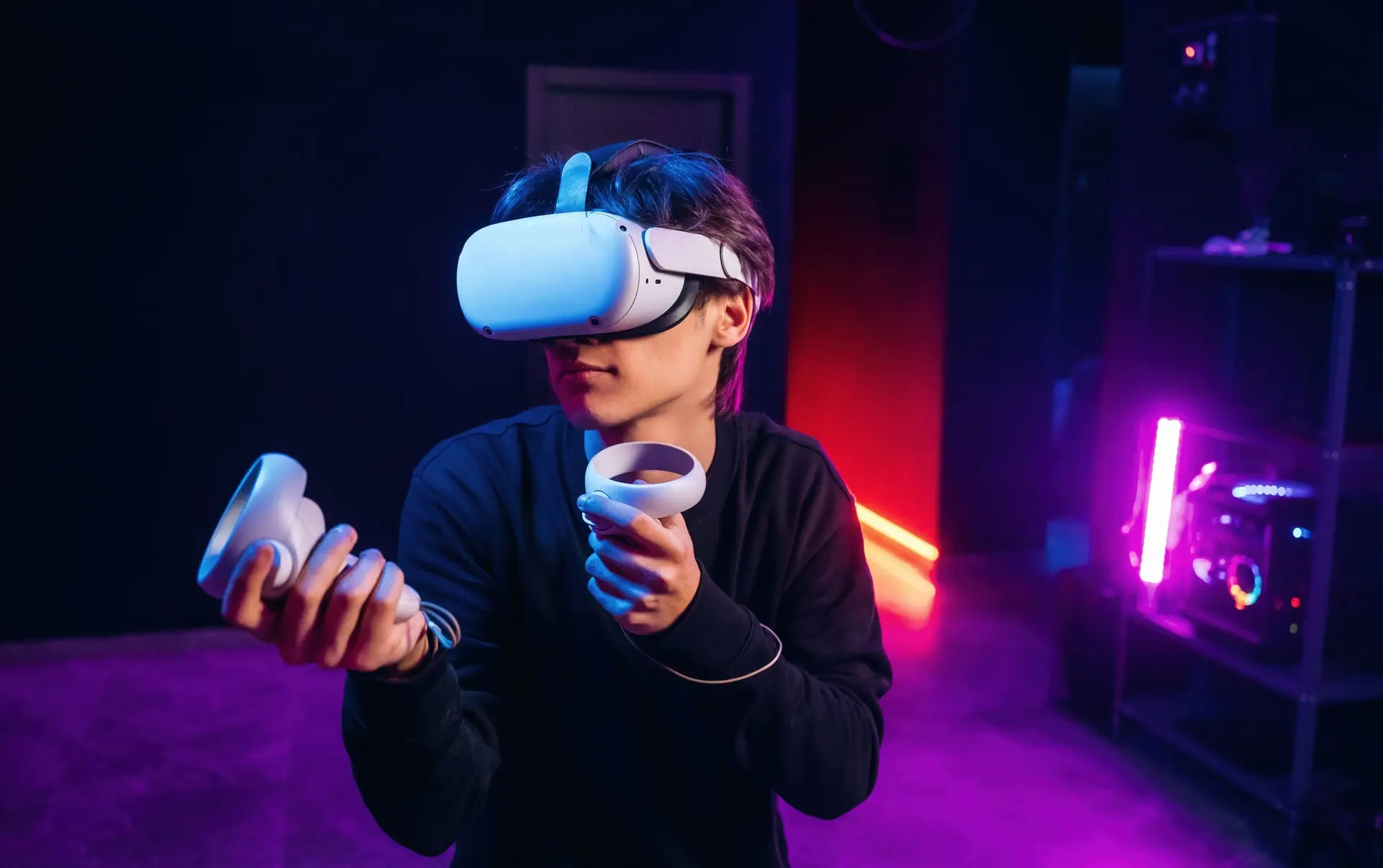 Young man is in virtual reality glasses indoors
